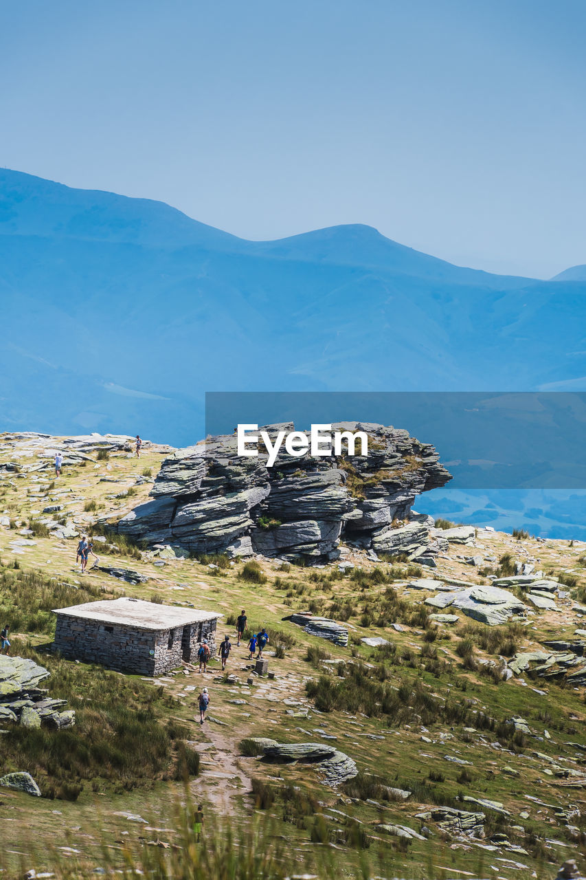 BUILT STRUCTURE ON MOUNTAIN AGAINST SKY