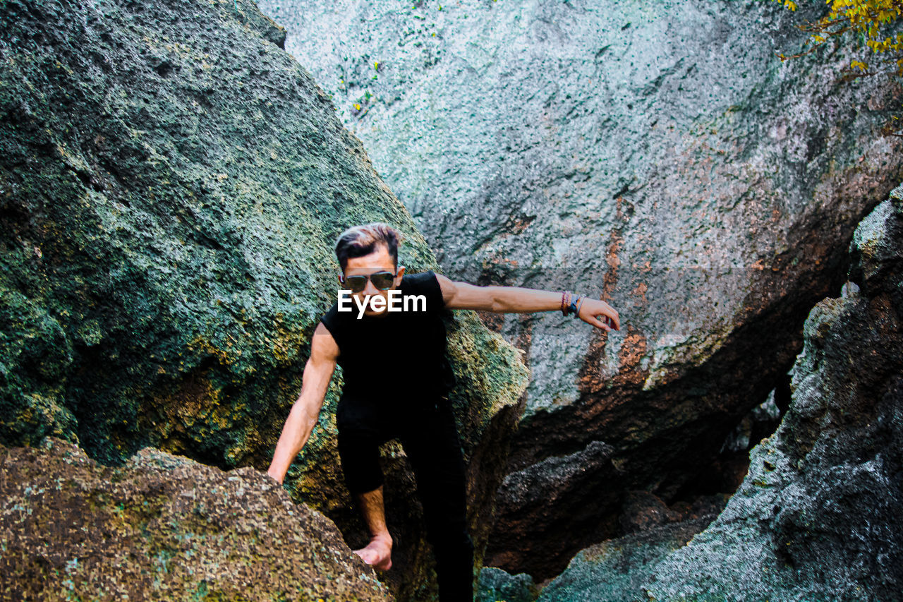 Young man standing on rock