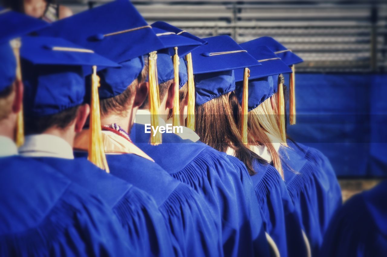 Rear view of students standing in row