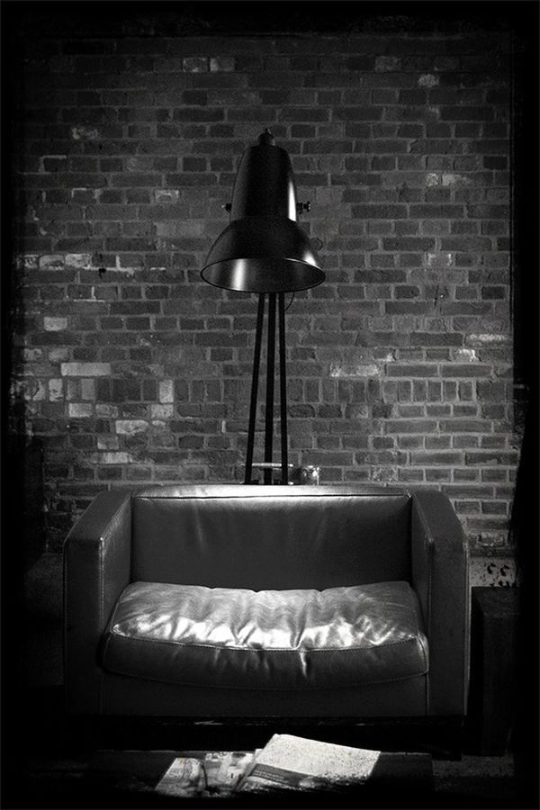 VIEW OF LAMP ON BRICK WALL