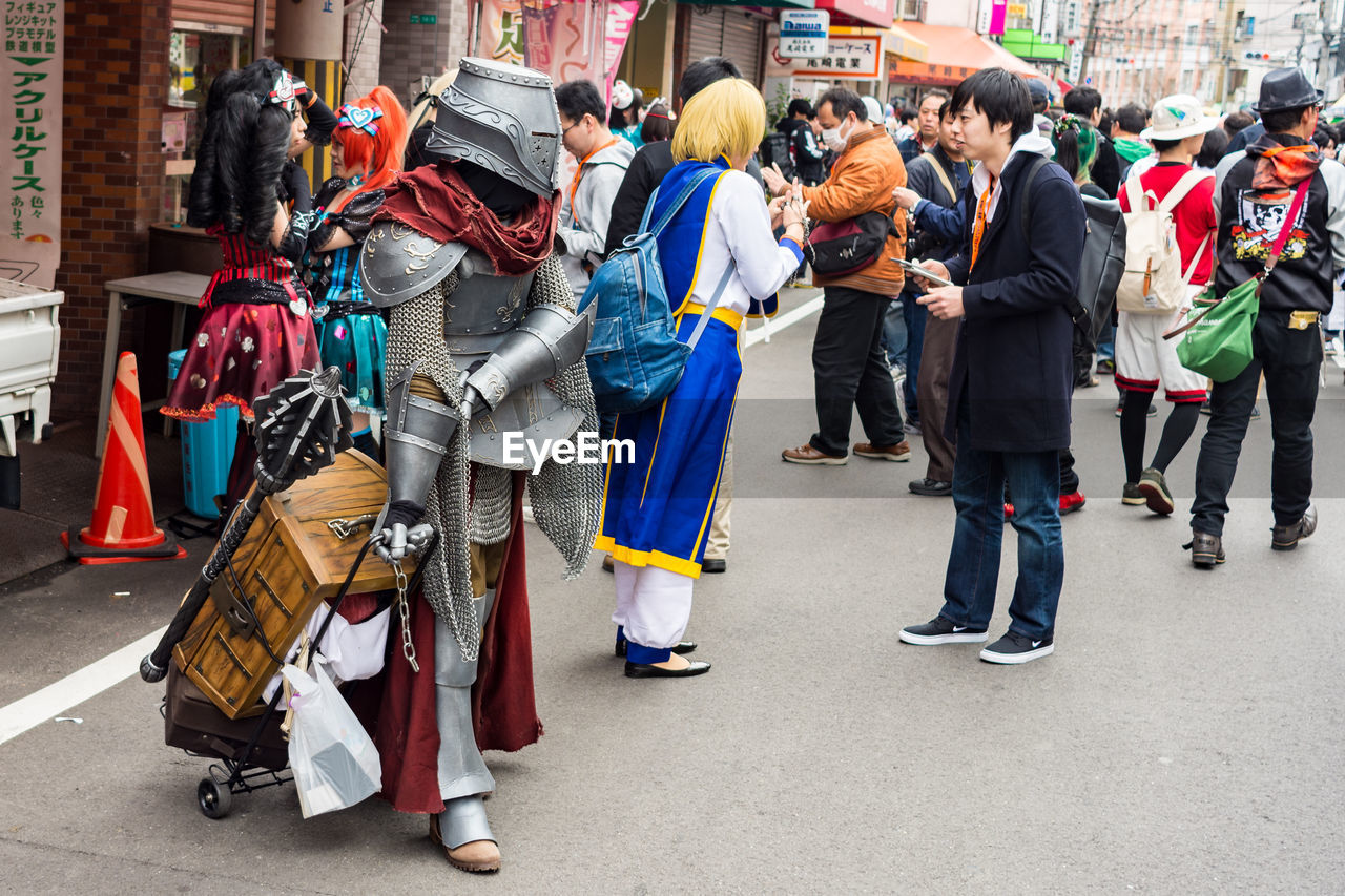 PEOPLE ON STREET IN CITY