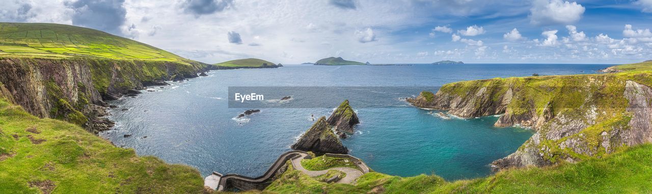 Dunquin pier and harbour with tall cliffs, turquoise water and islands, wild atlantic way, ireland