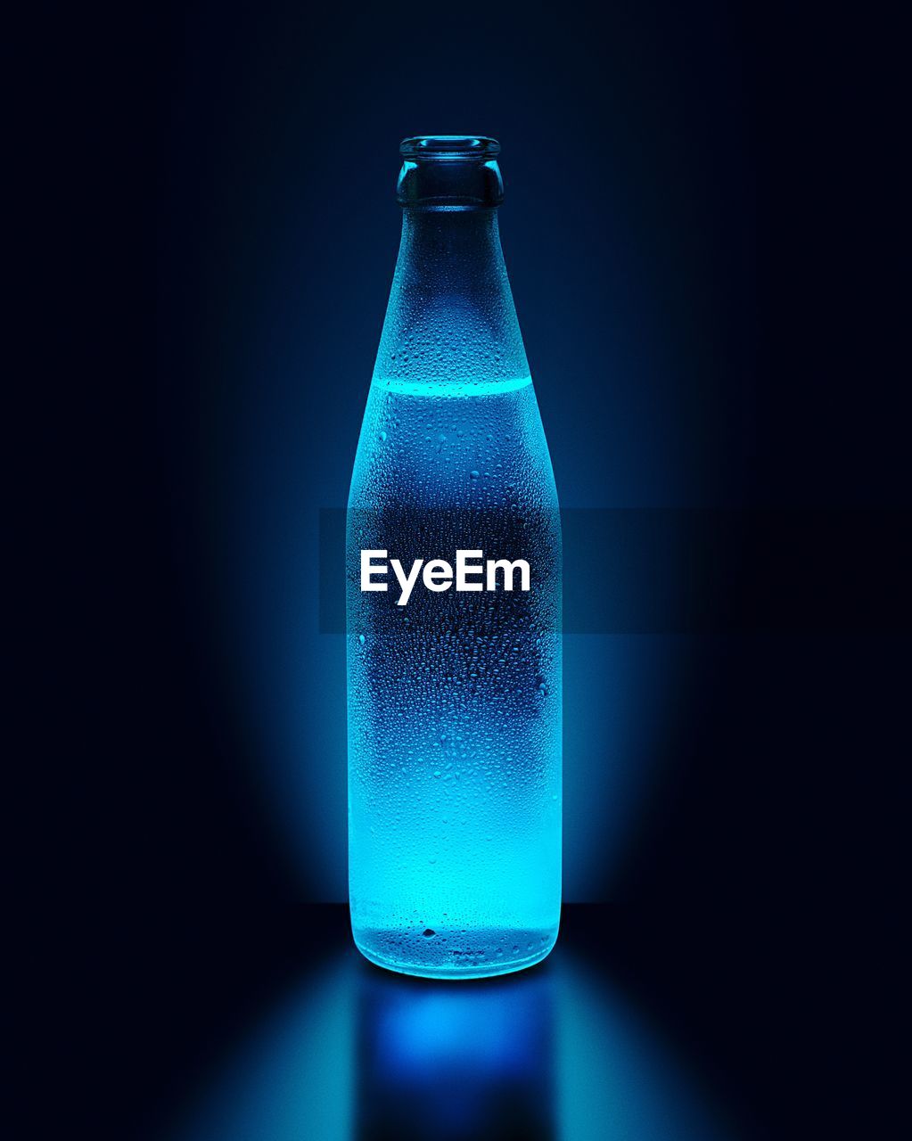 Close-up of drink in glass bottle against black background