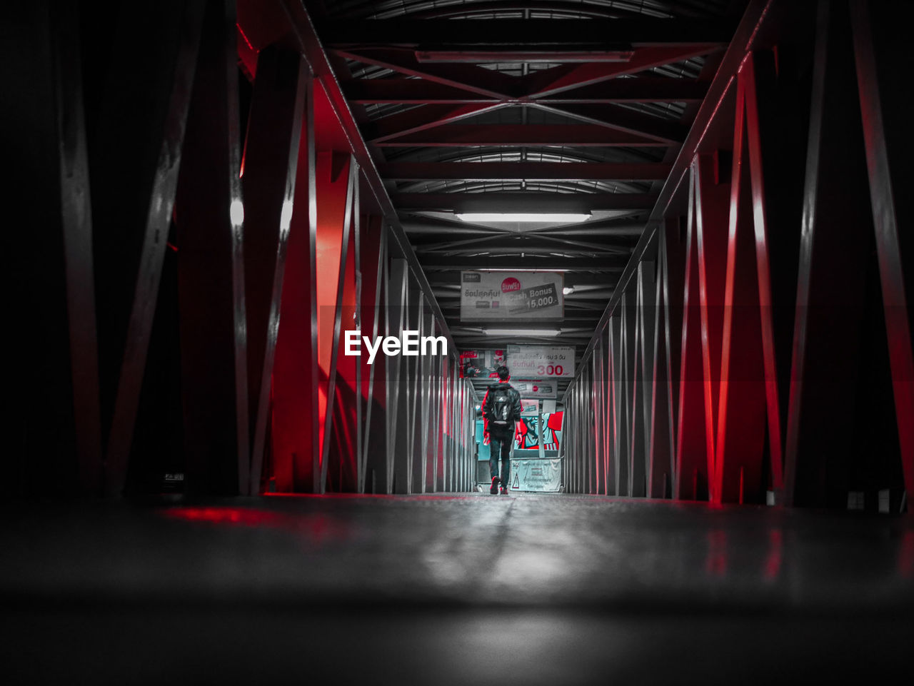 VIEW OF PEOPLE WALKING IN ILLUMINATED UNDERGROUND WALKWAY