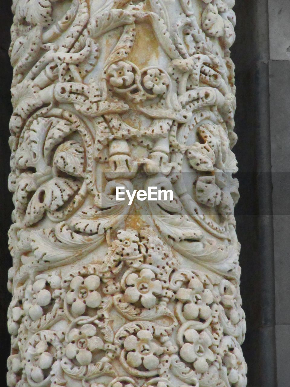 Ornate carvings on white column