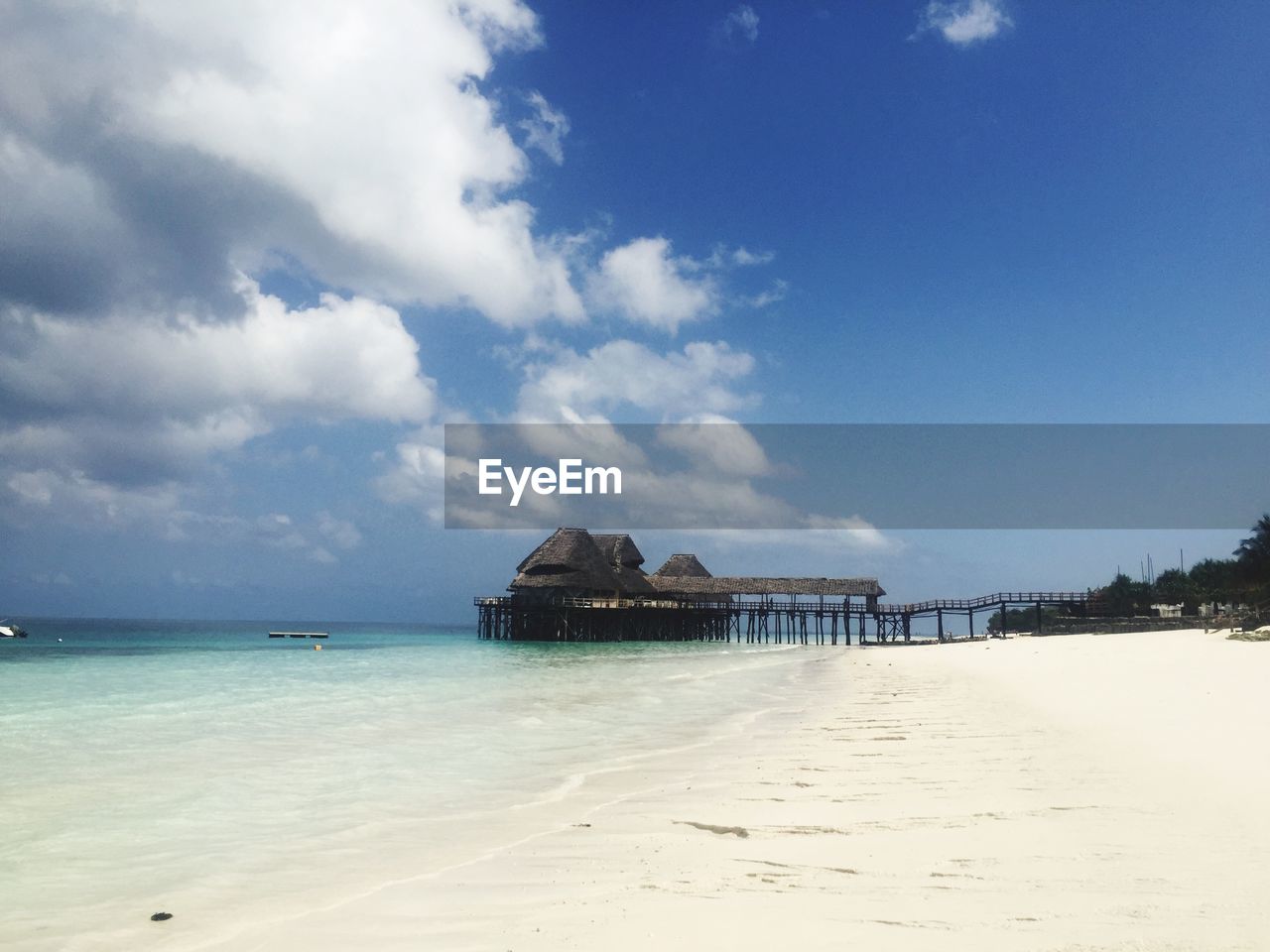 Surface level of calm beach against the sky