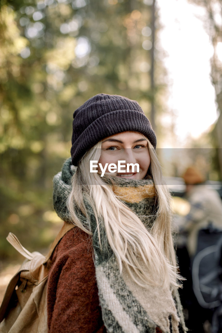 Portrait of smiling blond woman wearing knit hat