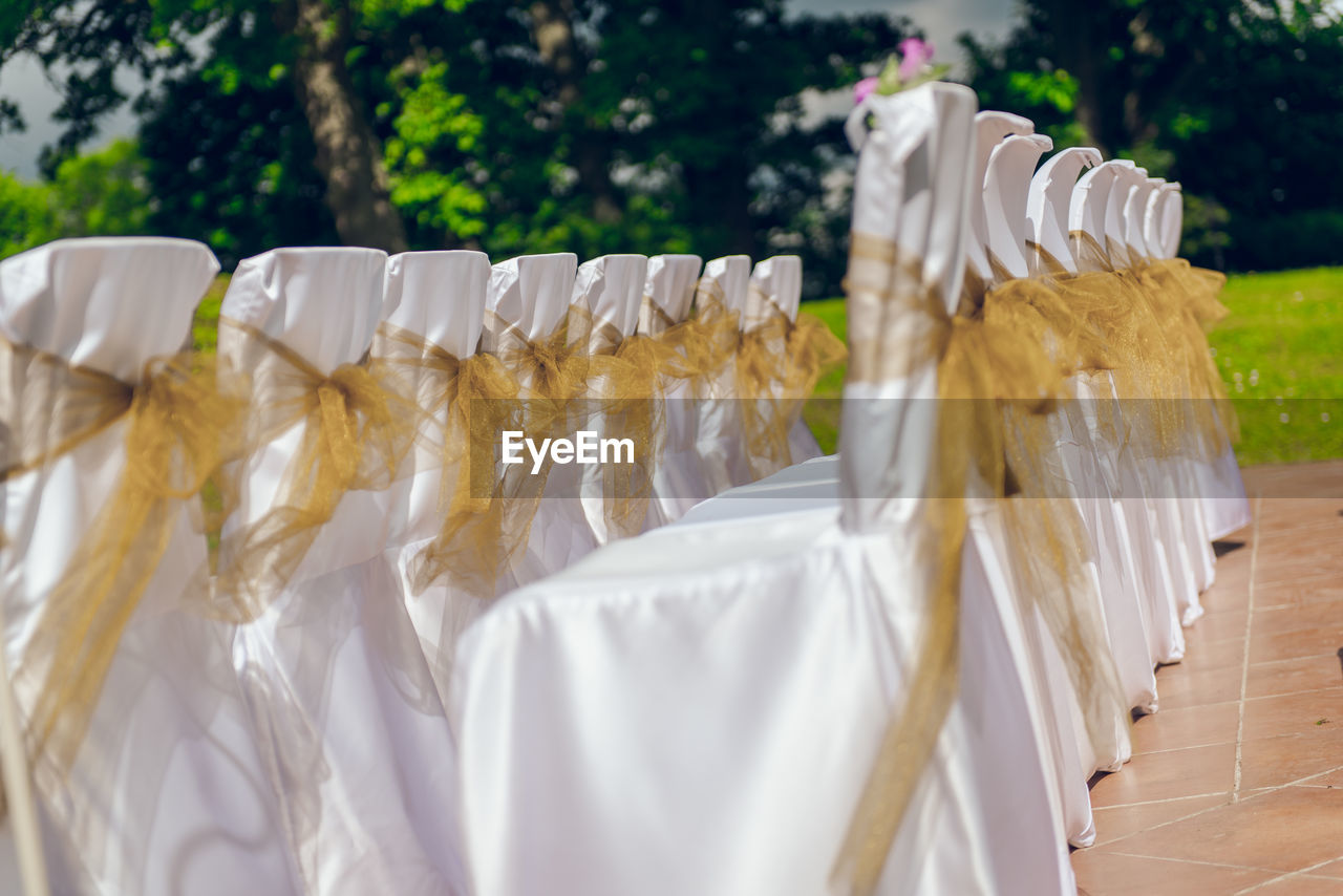 Arrangement of empty wedding chairs outdoors