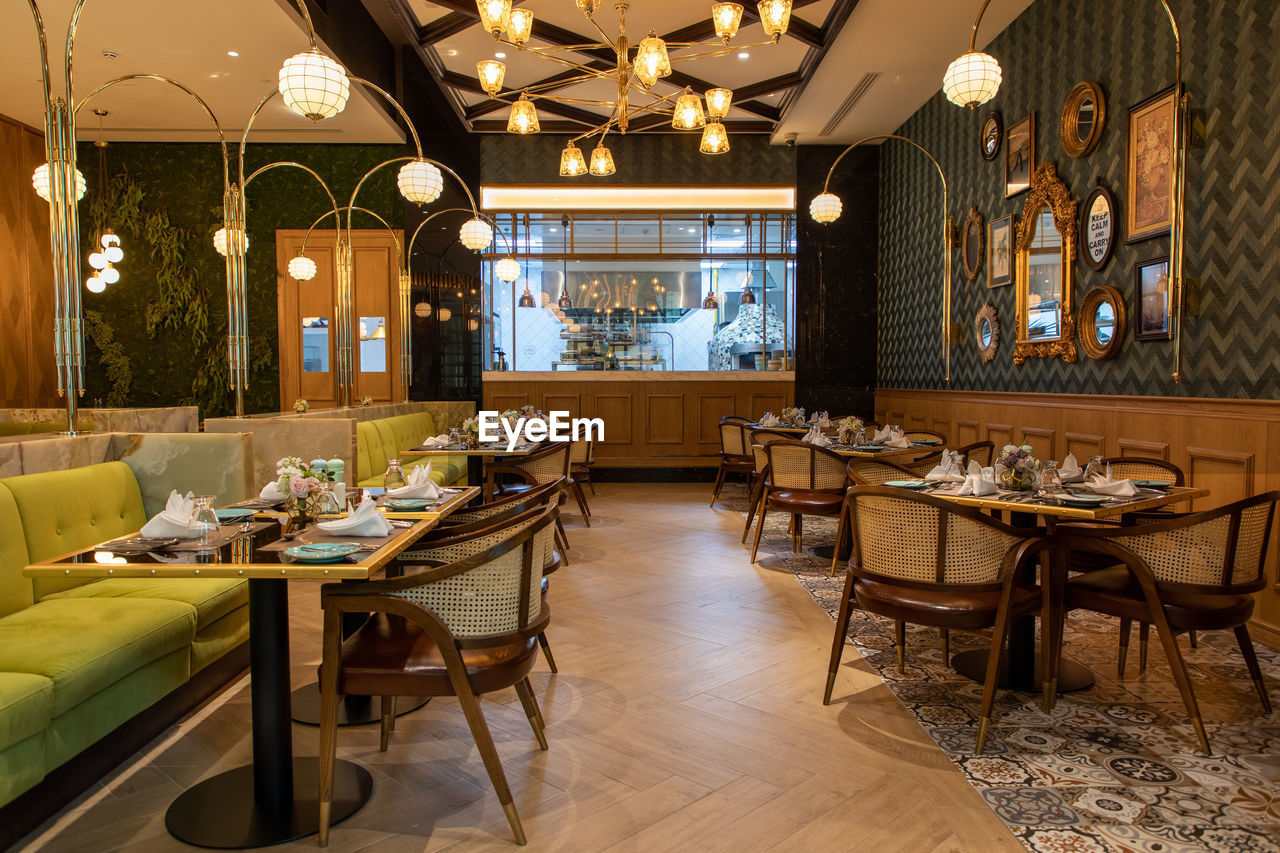 EMPTY CHAIRS AND TABLES AT RESTAURANT