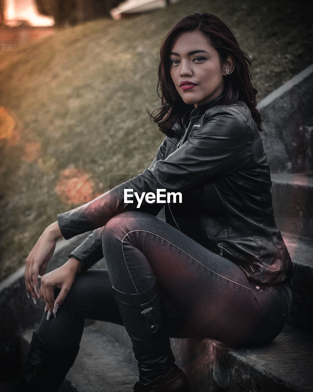 Portrait of young woman sitting on steps