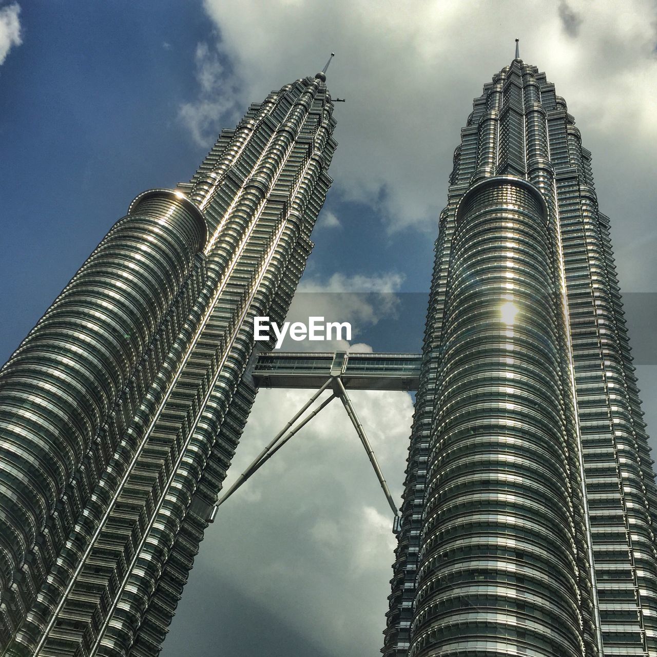 Low angle view of modern building against cloudy sky