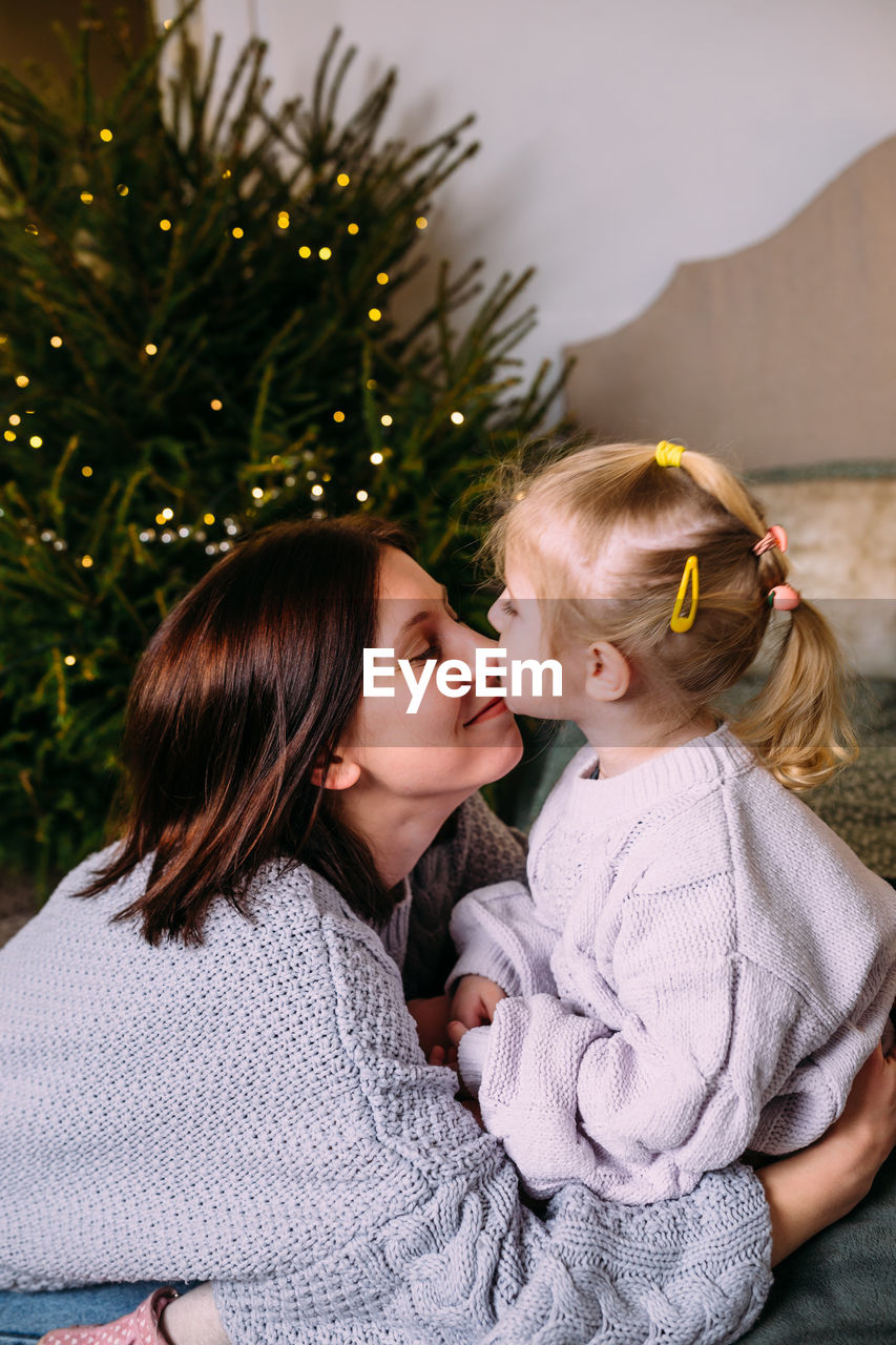 Mother and daughter having fun and relaxing at home. xmas and new year concept