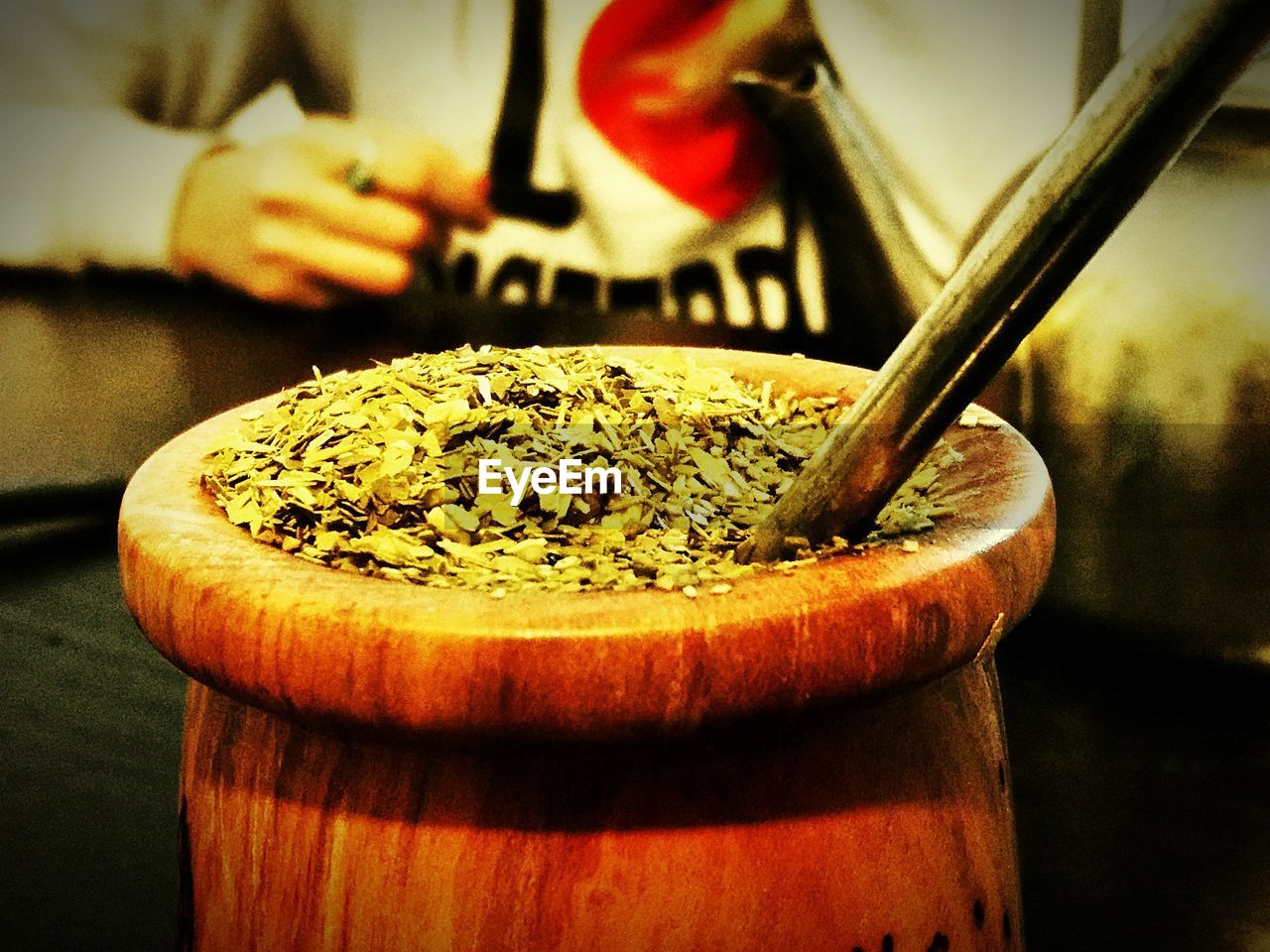 CLOSE-UP OF HAND HOLDING BREAD IN CONTAINER