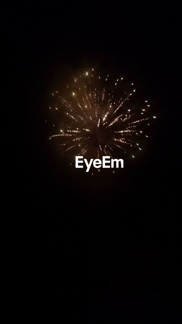 LOW ANGLE VIEW OF FIREWORKS AGAINST SKY AT NIGHT