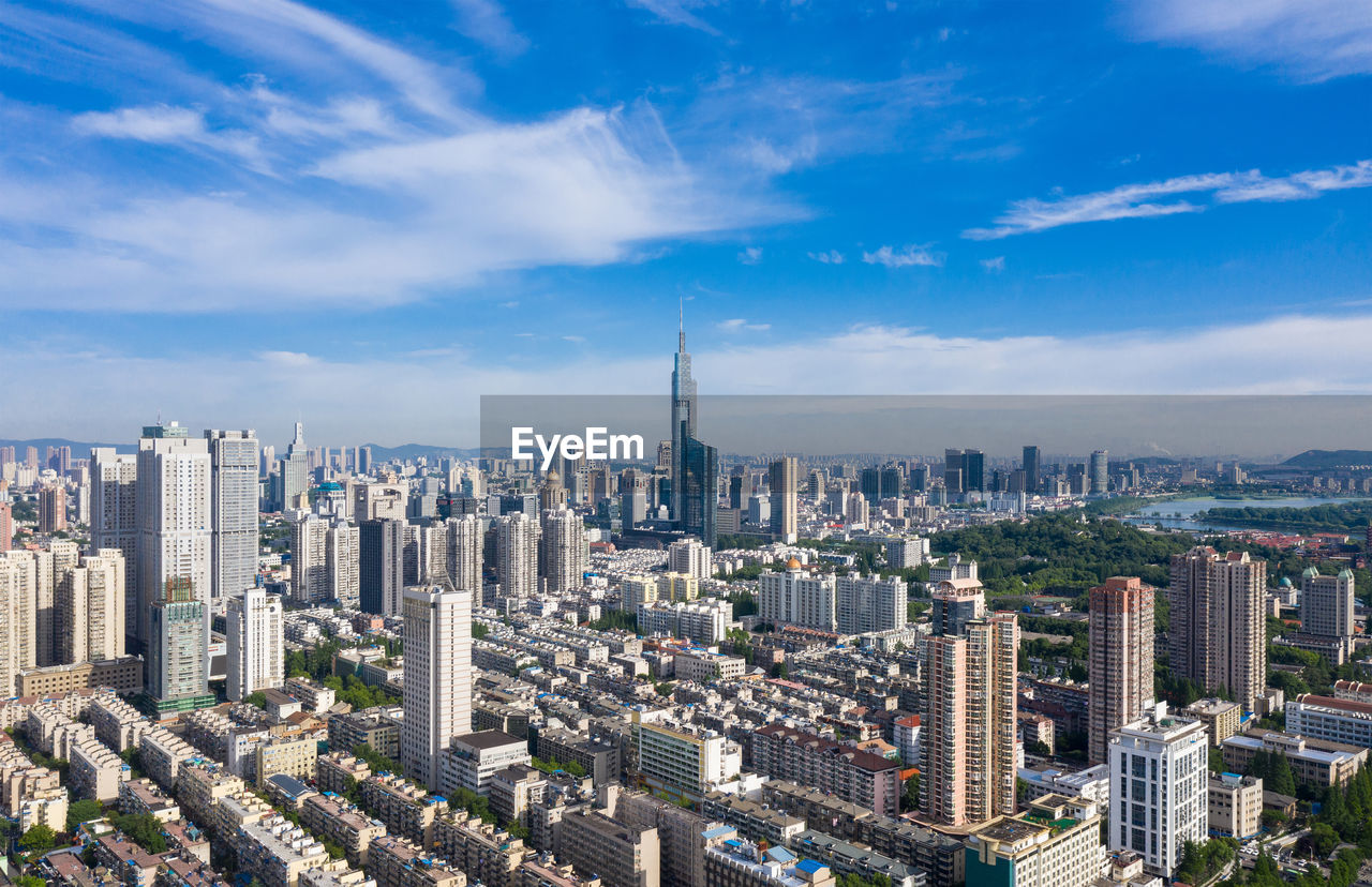 High angle view of modern buildings in city against sky
