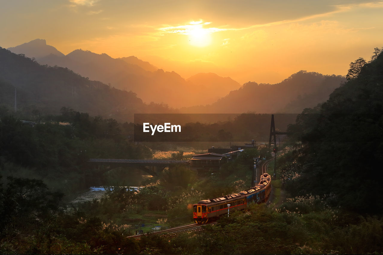 Train against mountains during sunset