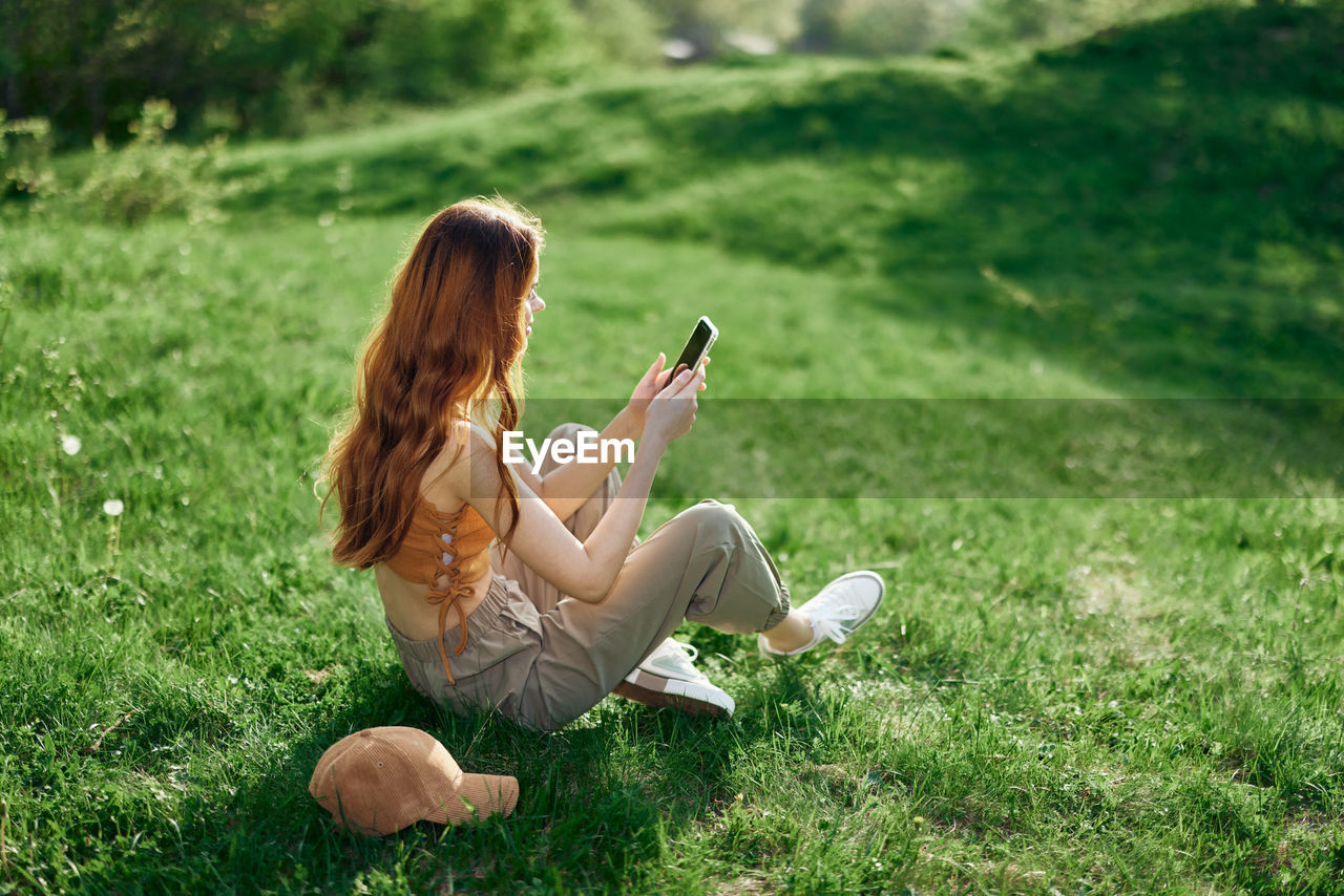 Side view of woman using mobile phone