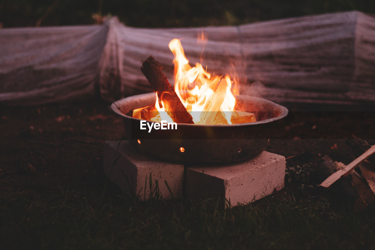 Close-up of bonfire on field at night