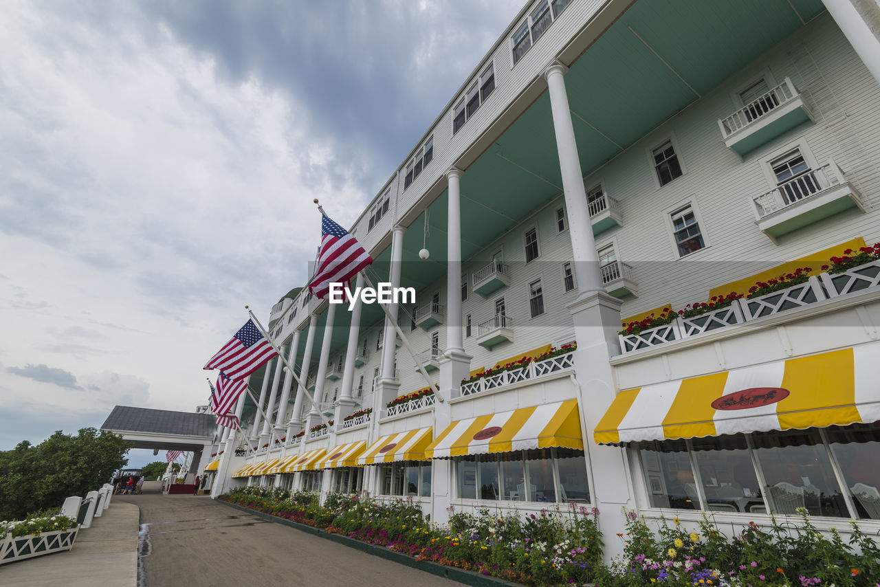 LOW ANGLE VIEW OF FLAGS AGAINST BUILDING