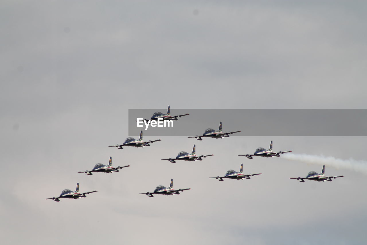 LOW ANGLE VIEW OF AIRPLANES FLYING IN SKY