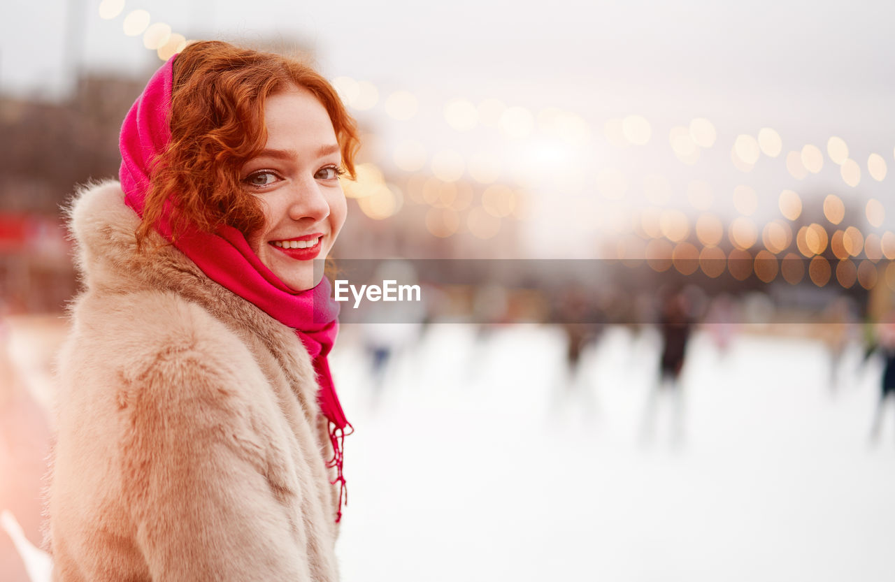 Portrait of smiling young woman standing outdoors