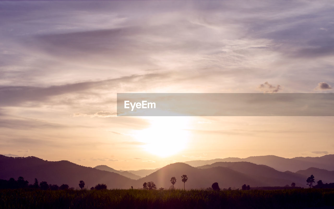 Scenic view of silhouette mountains against sky during sunset