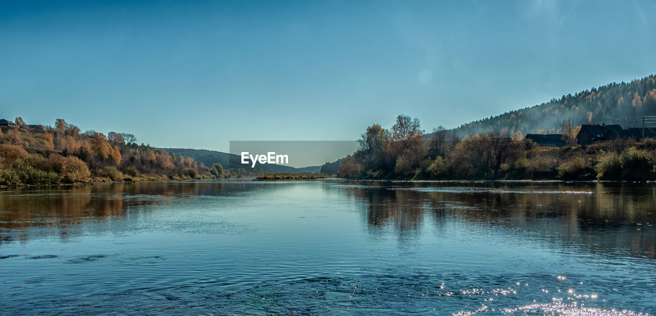 SCENIC VIEW OF LAKE AMIDST TREES AGAINST SKY