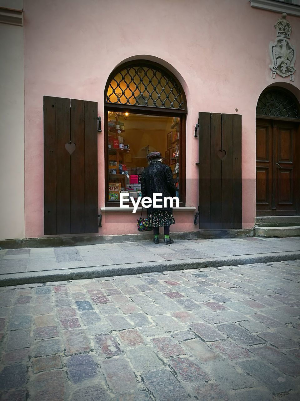 WOMAN IN FRONT OF A WINDOW