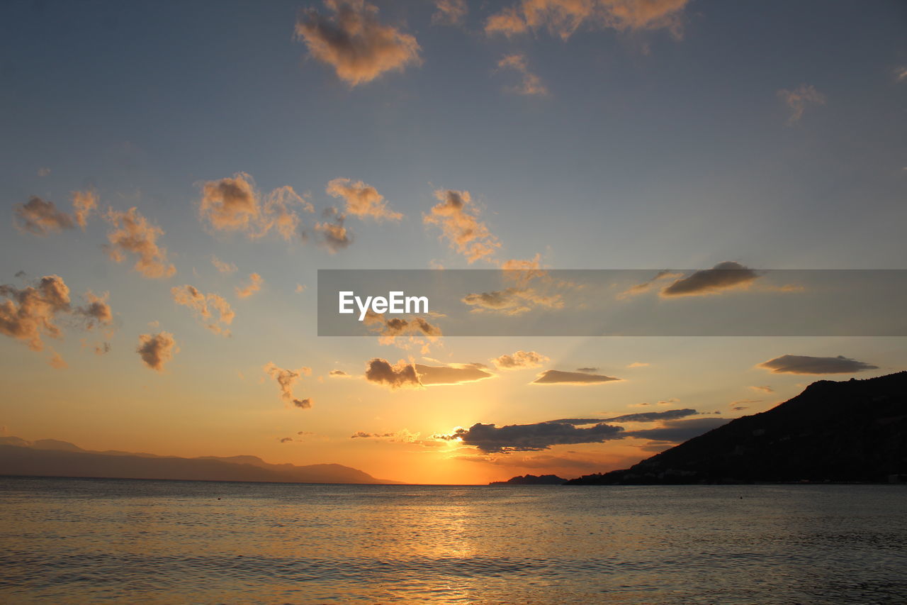 SCENIC VIEW OF SEA AGAINST ORANGE SKY