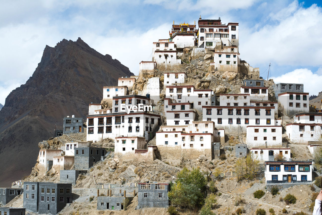 Buildings in front of old town against sky