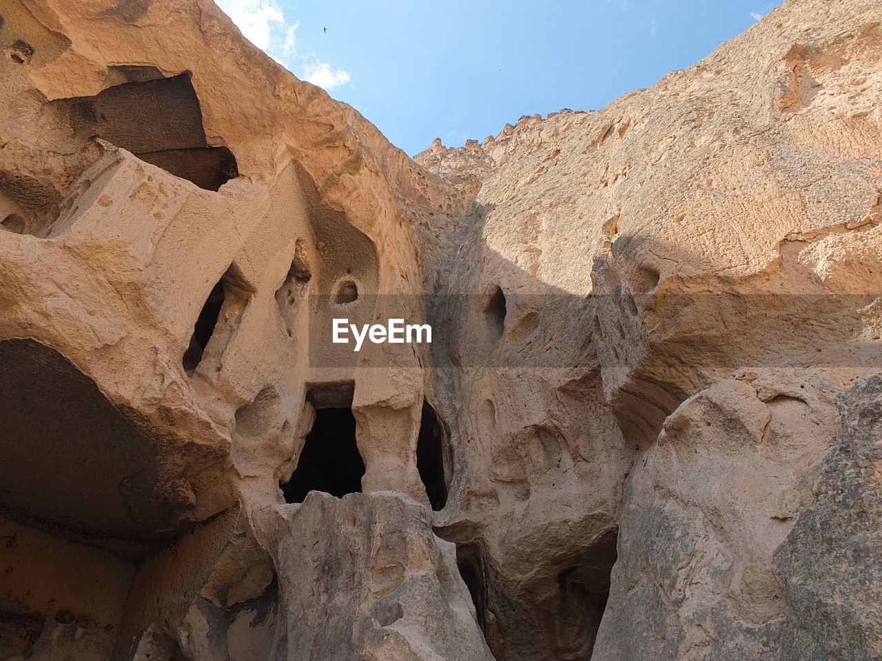 LOW ANGLE VIEW OF ROCK FORMATIONS AGAINST SKY