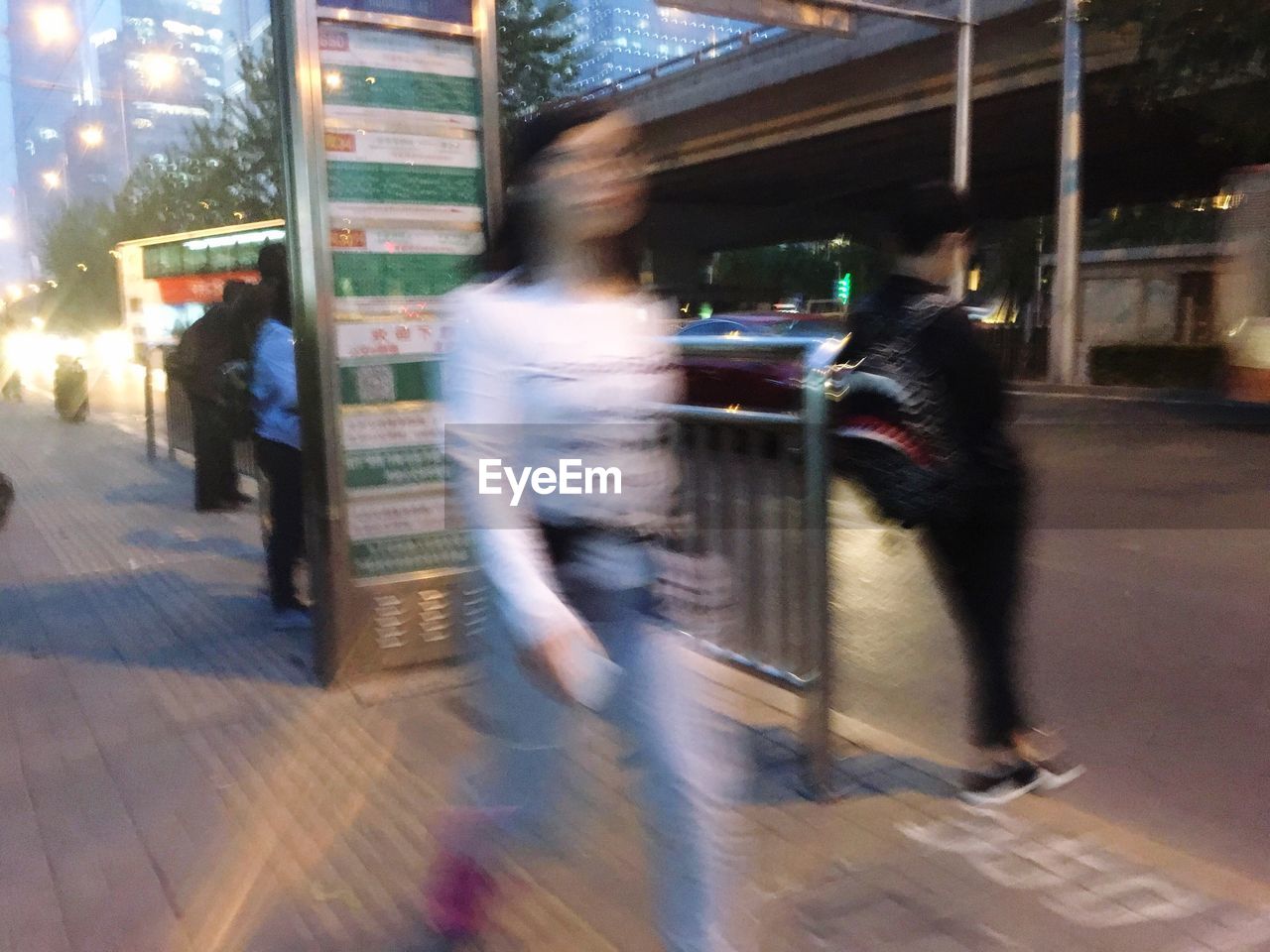 BLURRED MOTION OF PEOPLE WALKING ON STREET IN CITY