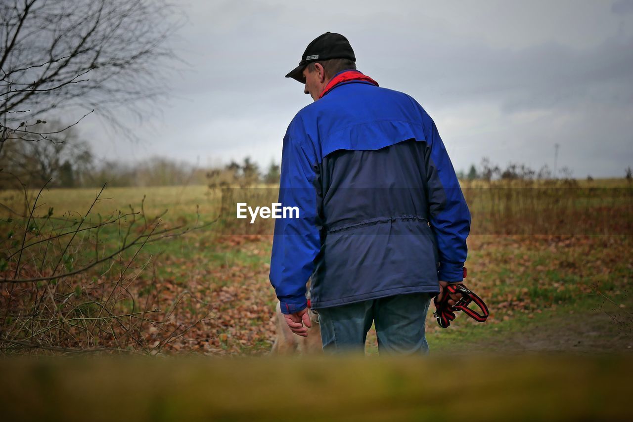 Rear view of man standing on field