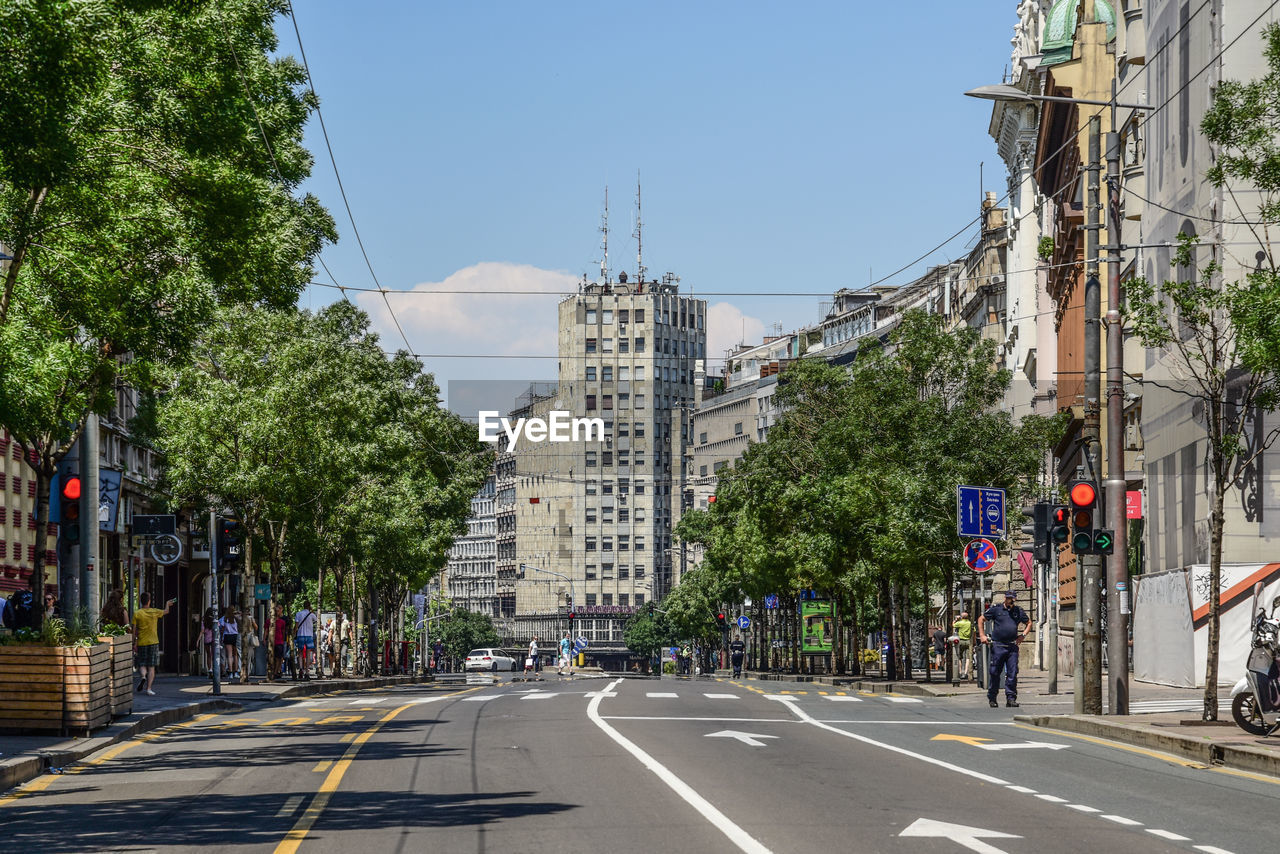 Road by buildings against sky in city, terazije square, belgrade, albania palace