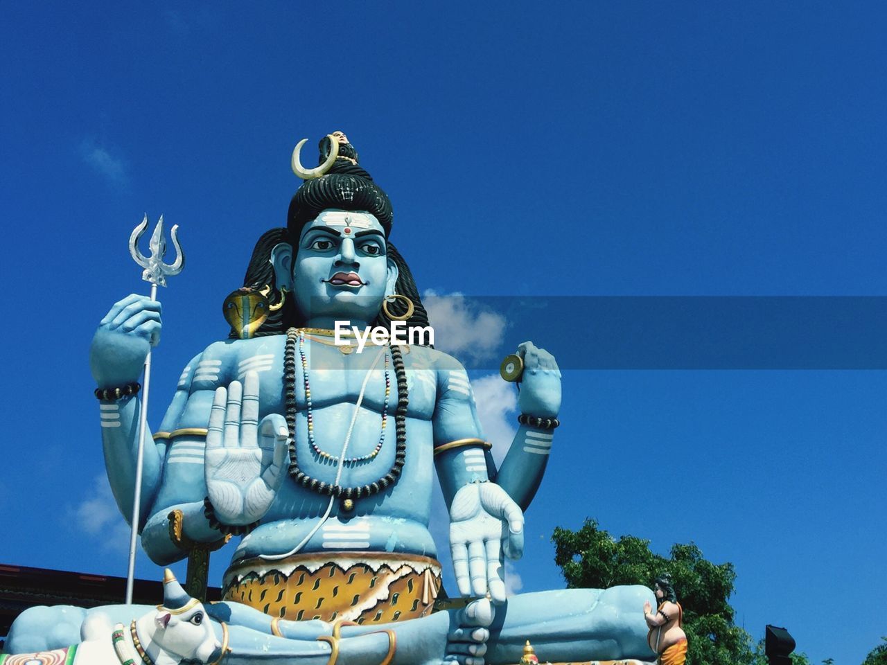 Statue of shiva at koneswaram temple against sky