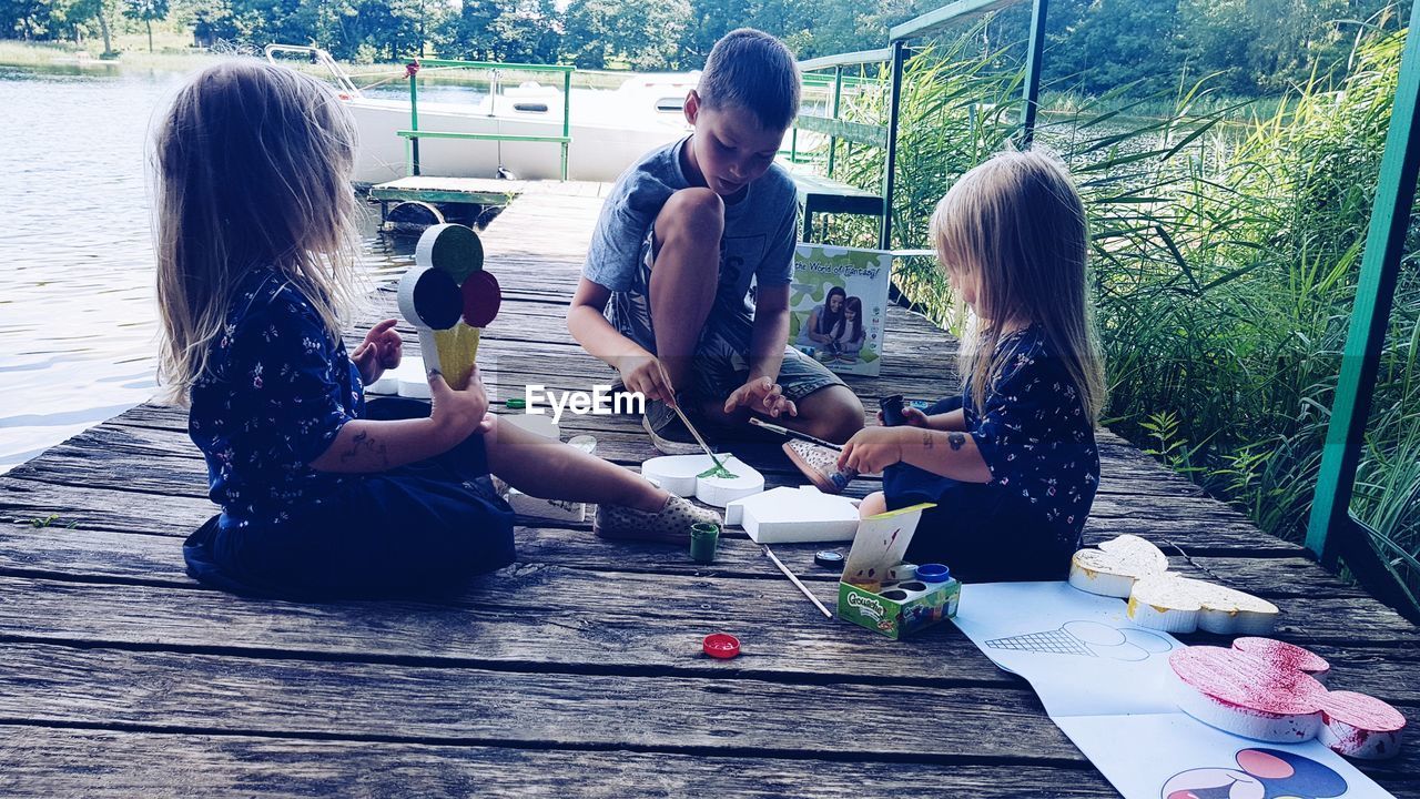 GROUP OF PEOPLE SITTING ON WOODEN FLOOR