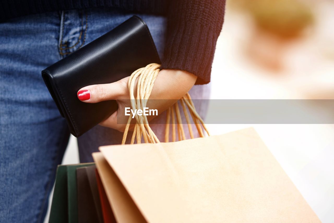 A woman with a wallet ready for online shopping