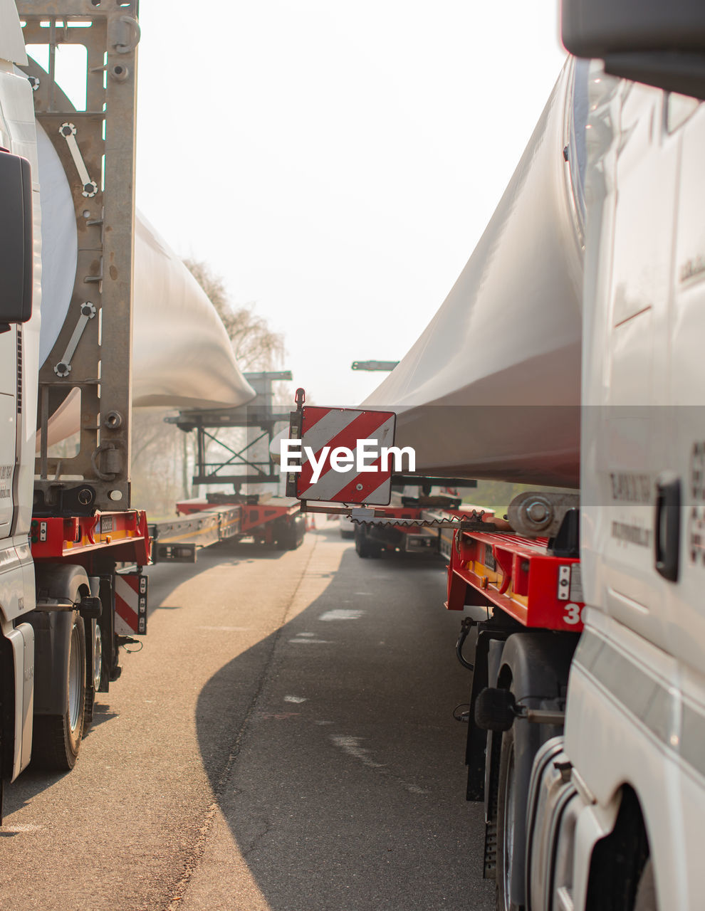 VEHICLES ON ROAD AGAINST SKY