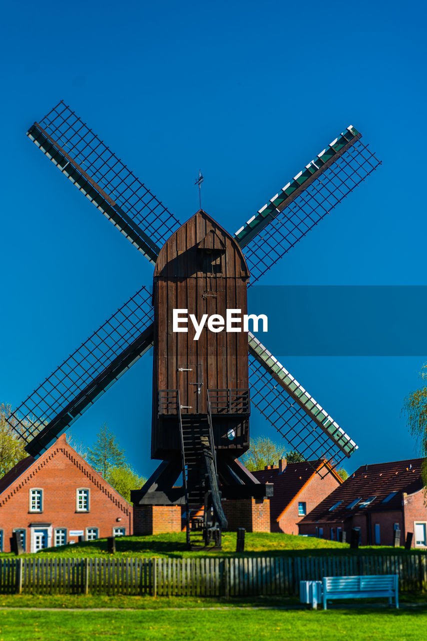 Traditional windmill against clear blue sky