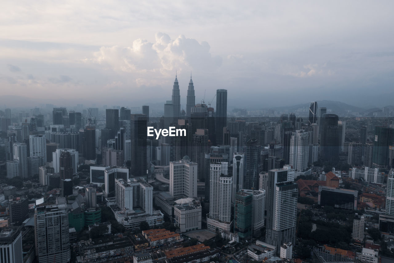 AERIAL VIEW OF MODERN CITY BUILDINGS AGAINST SKY