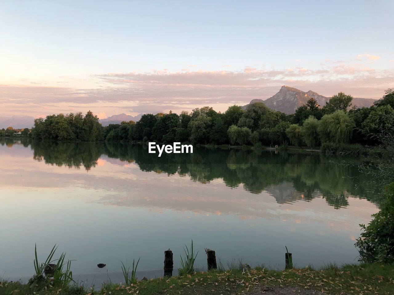 Scenic view of lake against sky at sunset