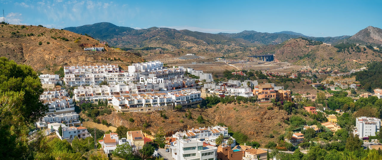 High angle view of townscape and mountains against sky