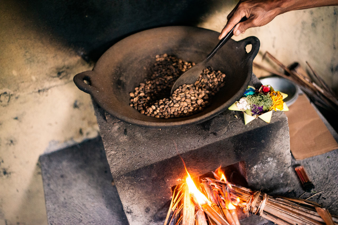 heat, food, food and drink, burning, fire, flame, kitchen utensil, hand, freshness, cooking, one person, household equipment, nature, iron, wood, cooking pan, preparing food, holding, metal, adult, motion, appliance, fried