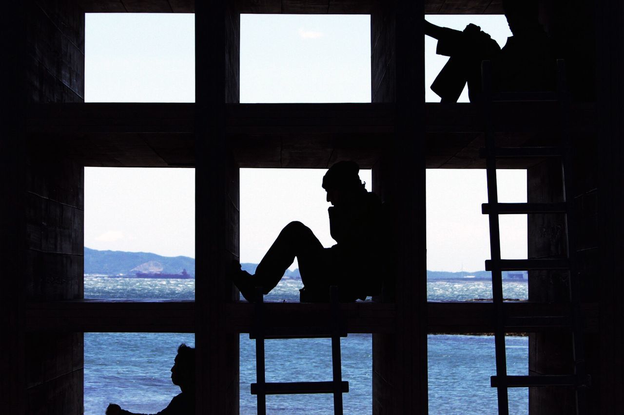 Silhouette of men at seaside