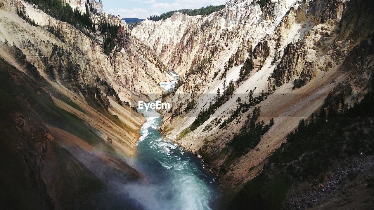 Scenic view of waterfall against sky