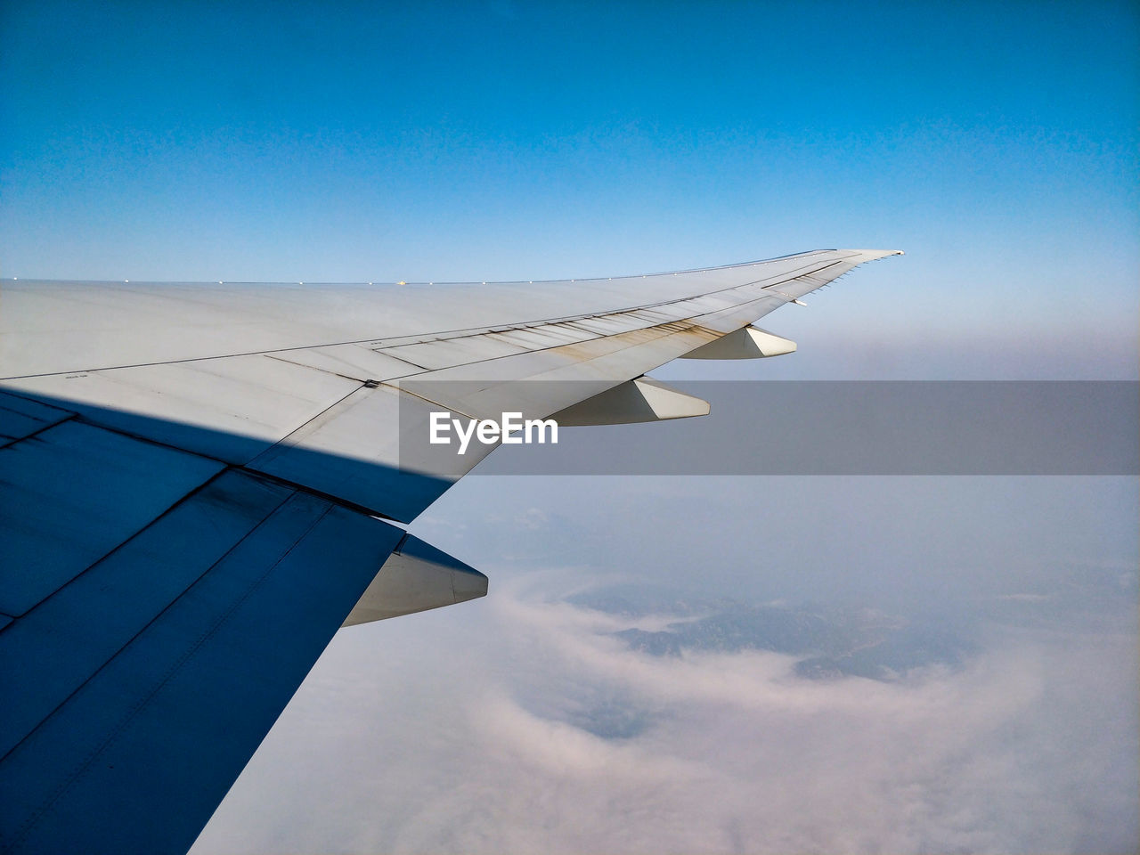 Aircraft wing against sky