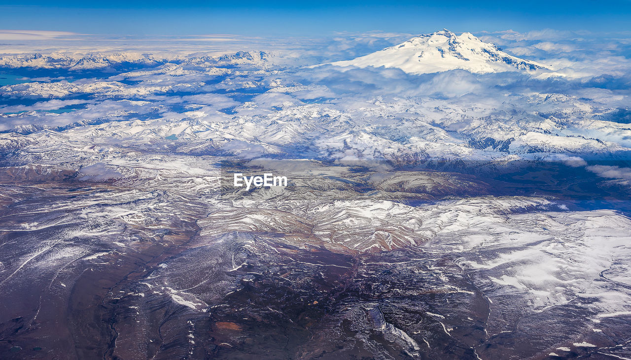 Aerial view of snowcapped mountains against sky