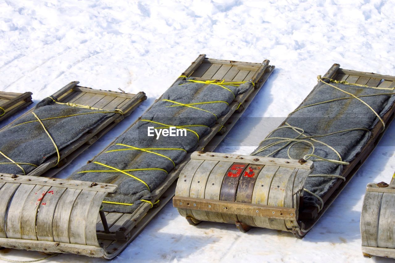 High angle view of sleds on snow covered field