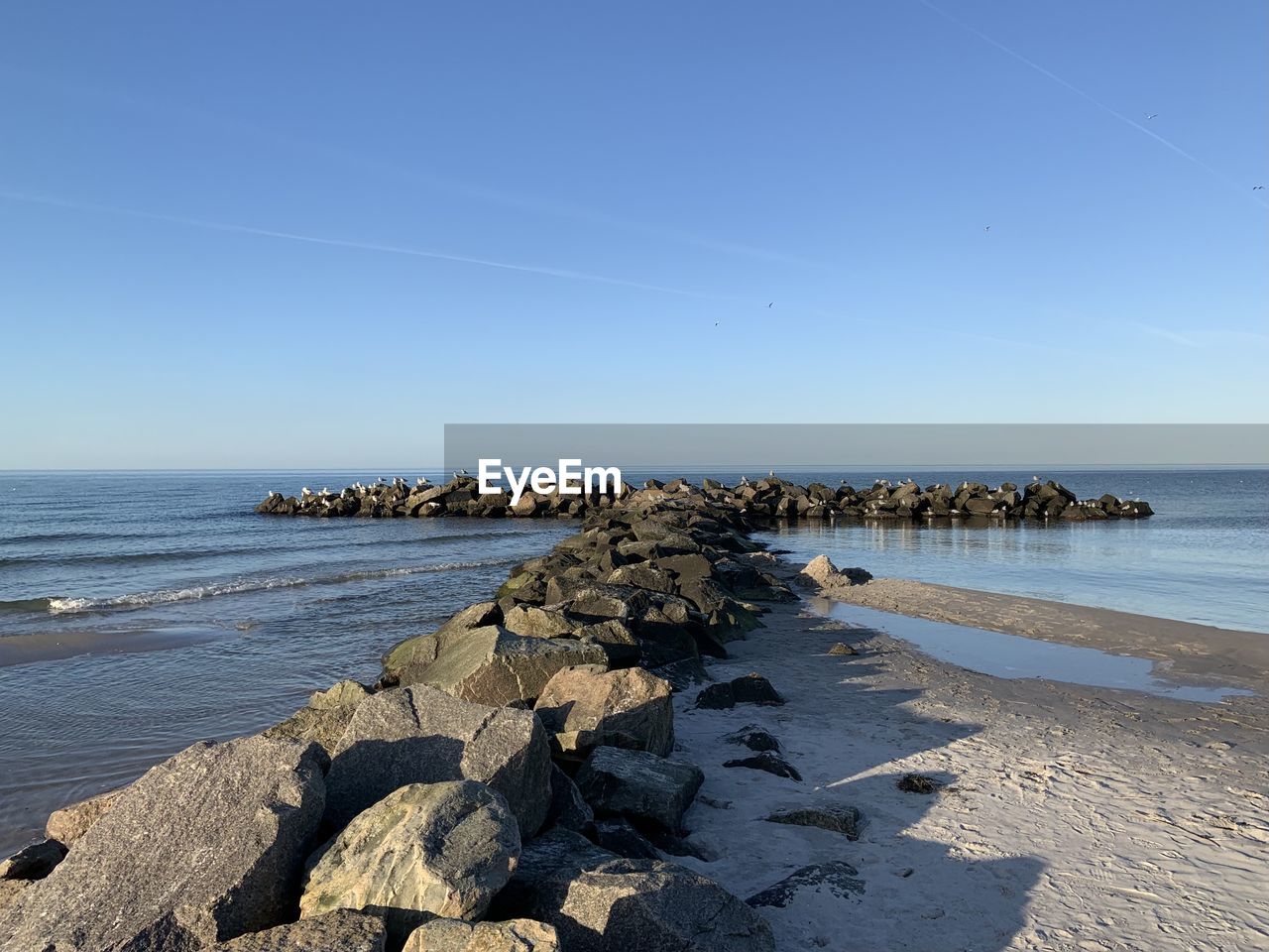 Scenic view of sea against clear blue sky