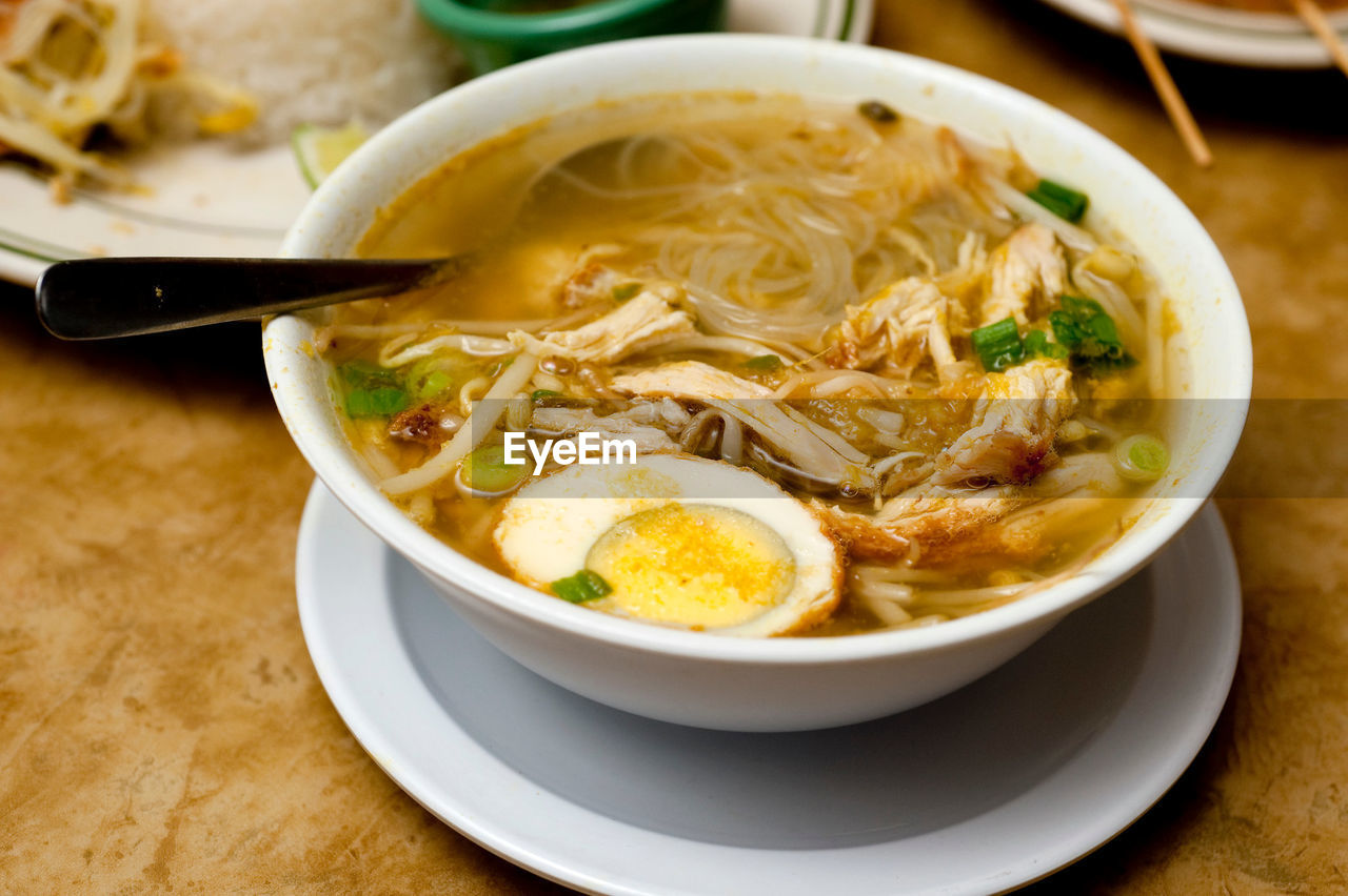 Close-up of soup in bowl on plate over table